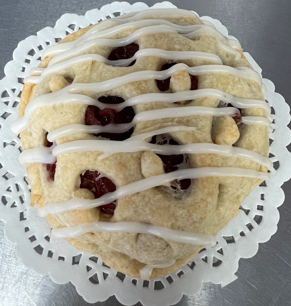Heart-shaped berry scone with icing drizzle